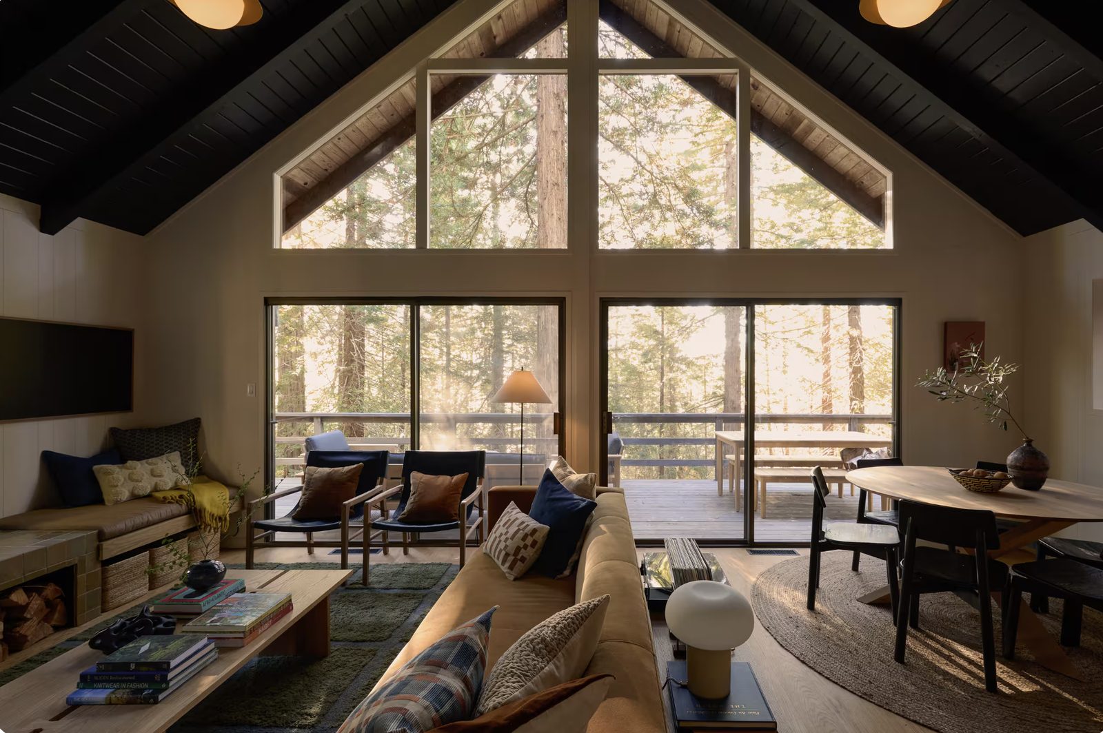 The remodeled Sea Ranch great room — redwoods through the A-frame glass.